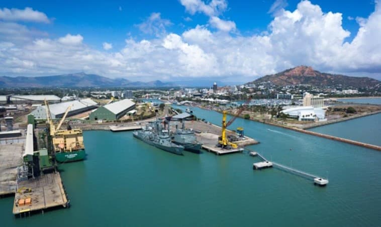 Aerial view of the Port of Townsville wharves, with the city and Castle Hill behind