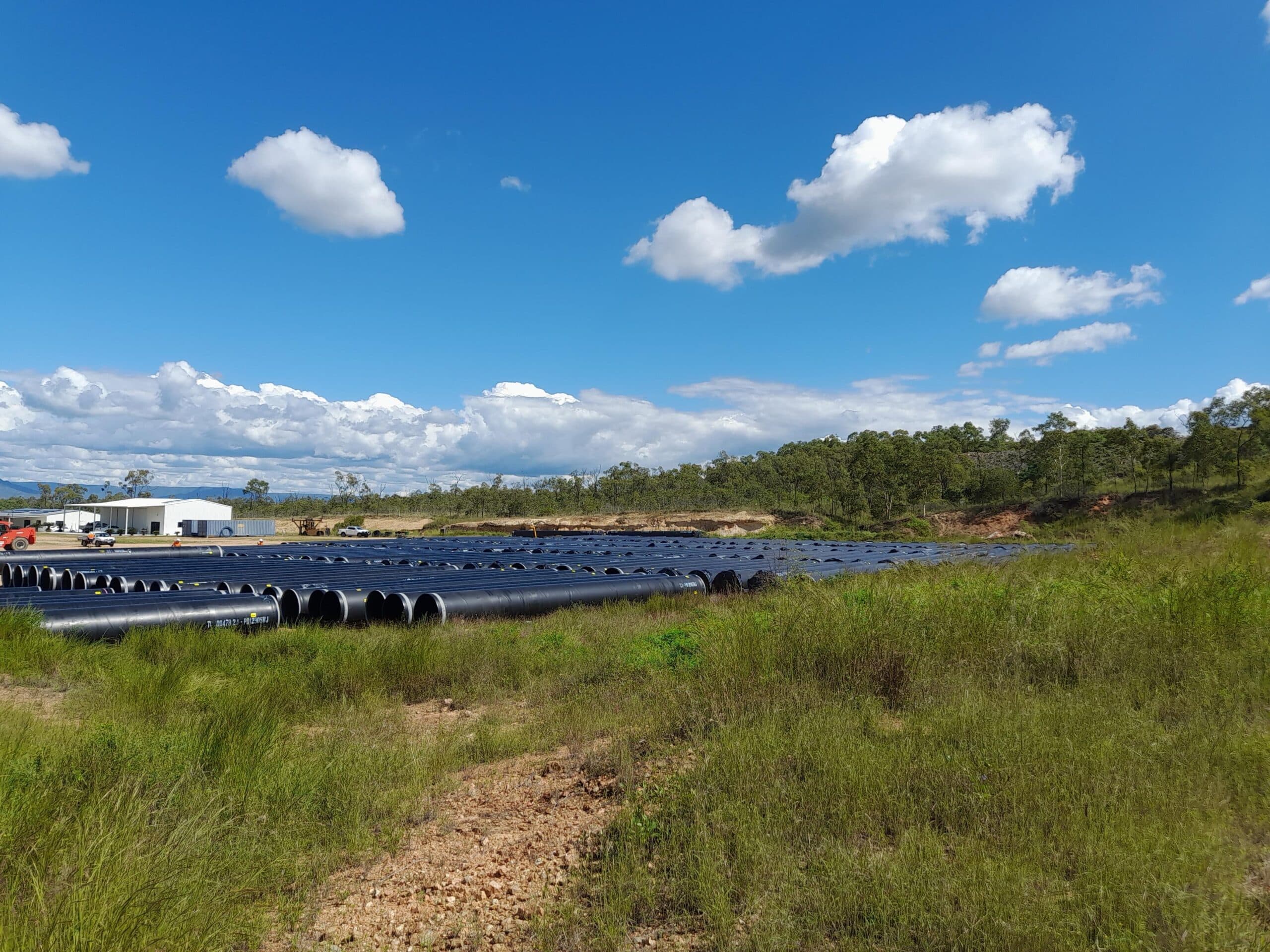 Rows of black MSCL pipe sections on open ground for the Ross River Dam to Douglas Water Treatment Plant duplication