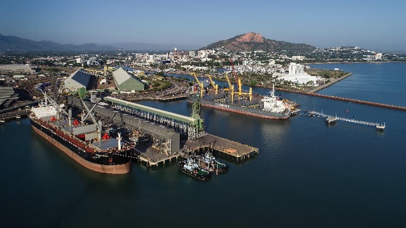 Aerial view of ships at berth in the Port of Townsville, with Castle Hill behind