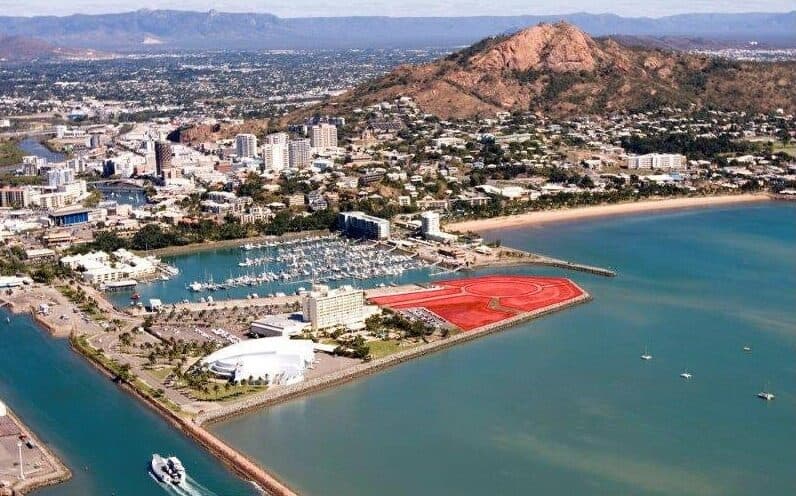 Aerial view of the Breakwater, Townsville, with the Saltwater development site highlighted in red and Castle Hill behind